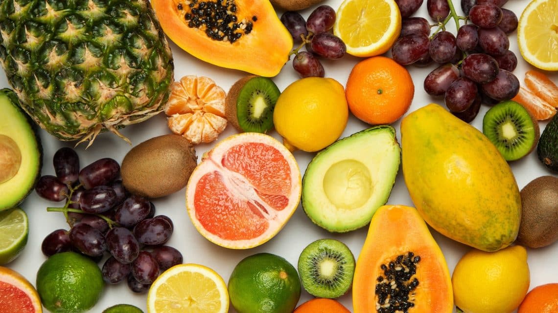 sliced orange fruit and green round fruits